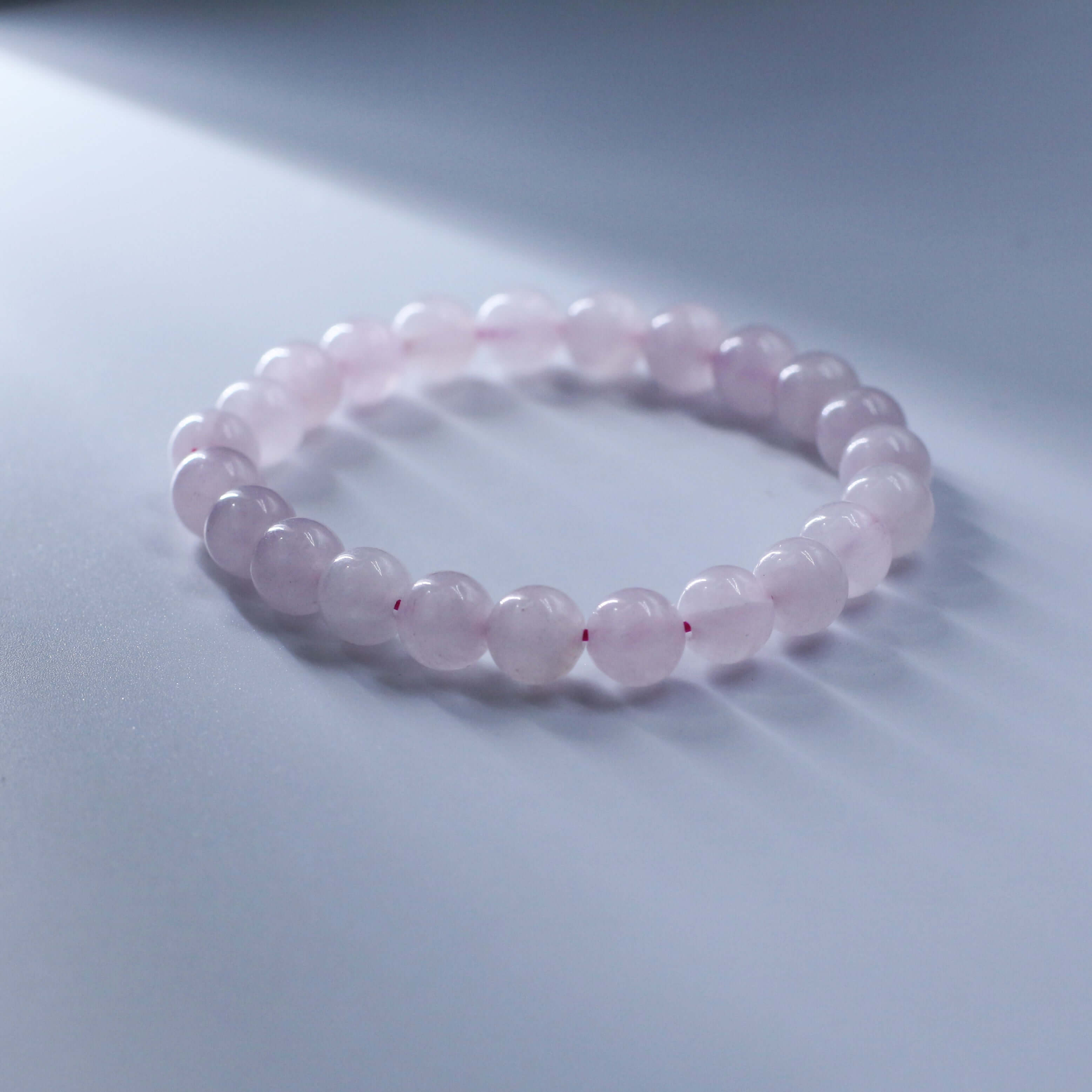 Romantic Rose Quartz Bracelet for Love and Relationships on a Light Background