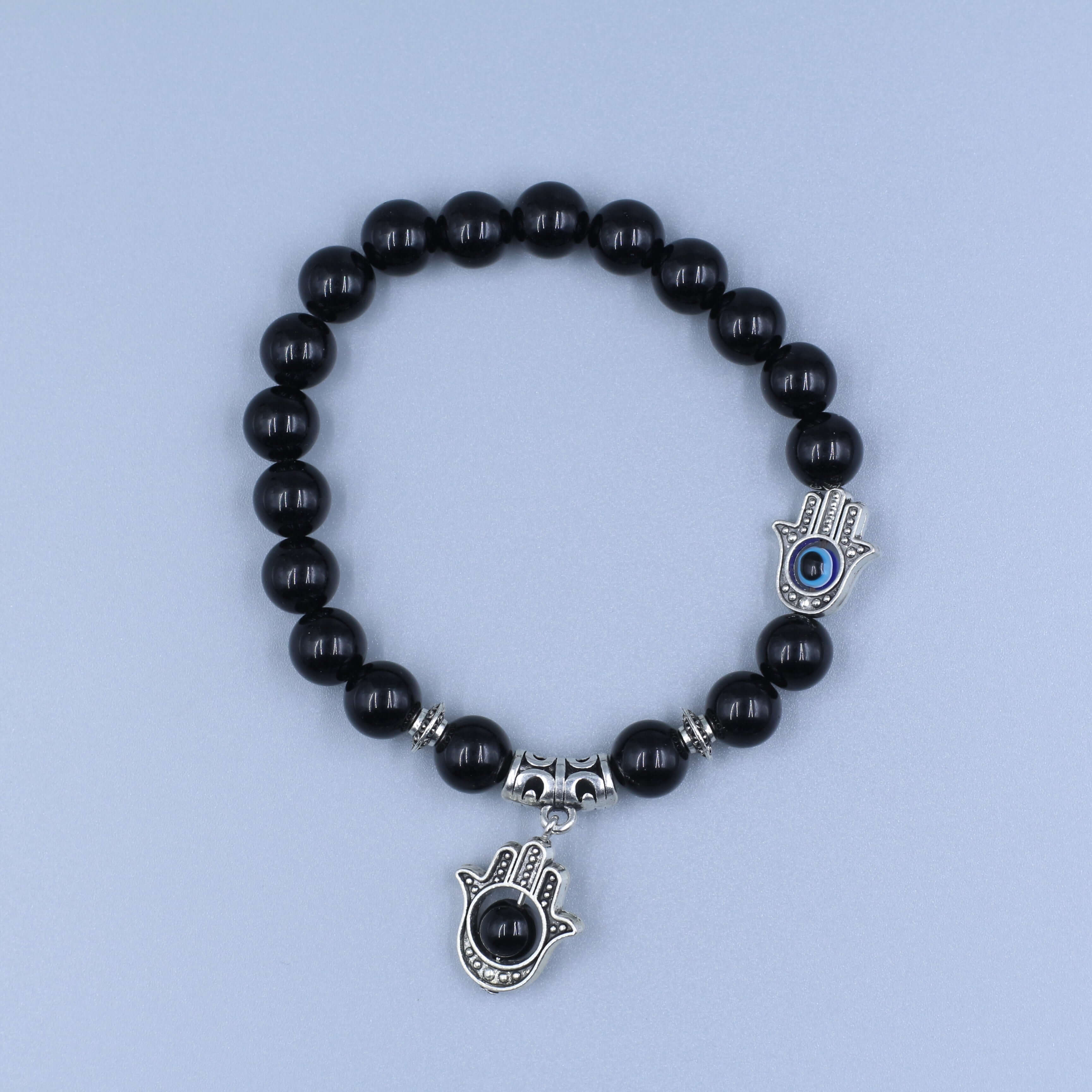 The Eye of Horus Bracelet-Health & Insight featuring black beads and protective charms on a light blue background