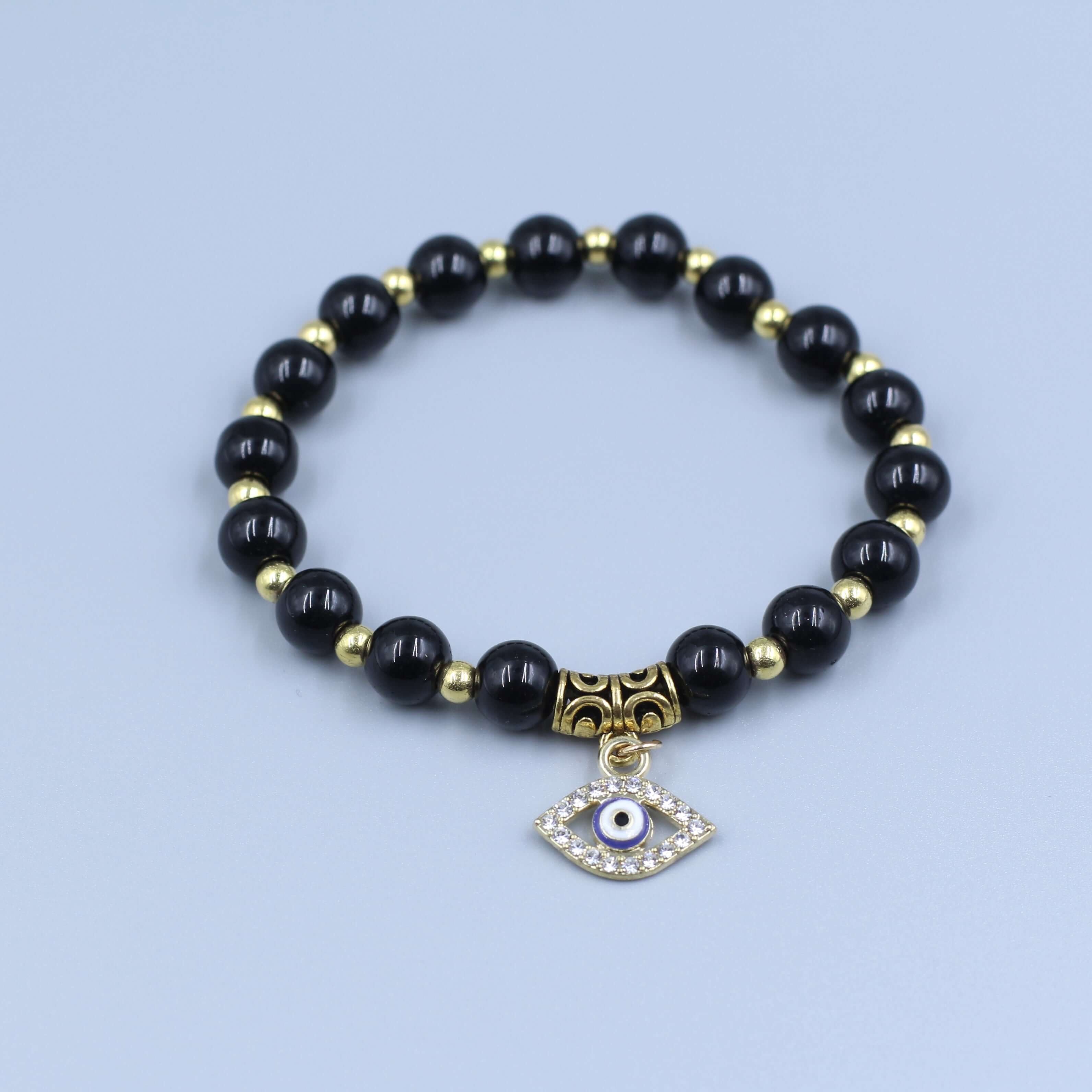 Black Evil Eye Bracelet-Protection with golden beads and an eye-shaped charm for warding off evil gazes and bad influences.