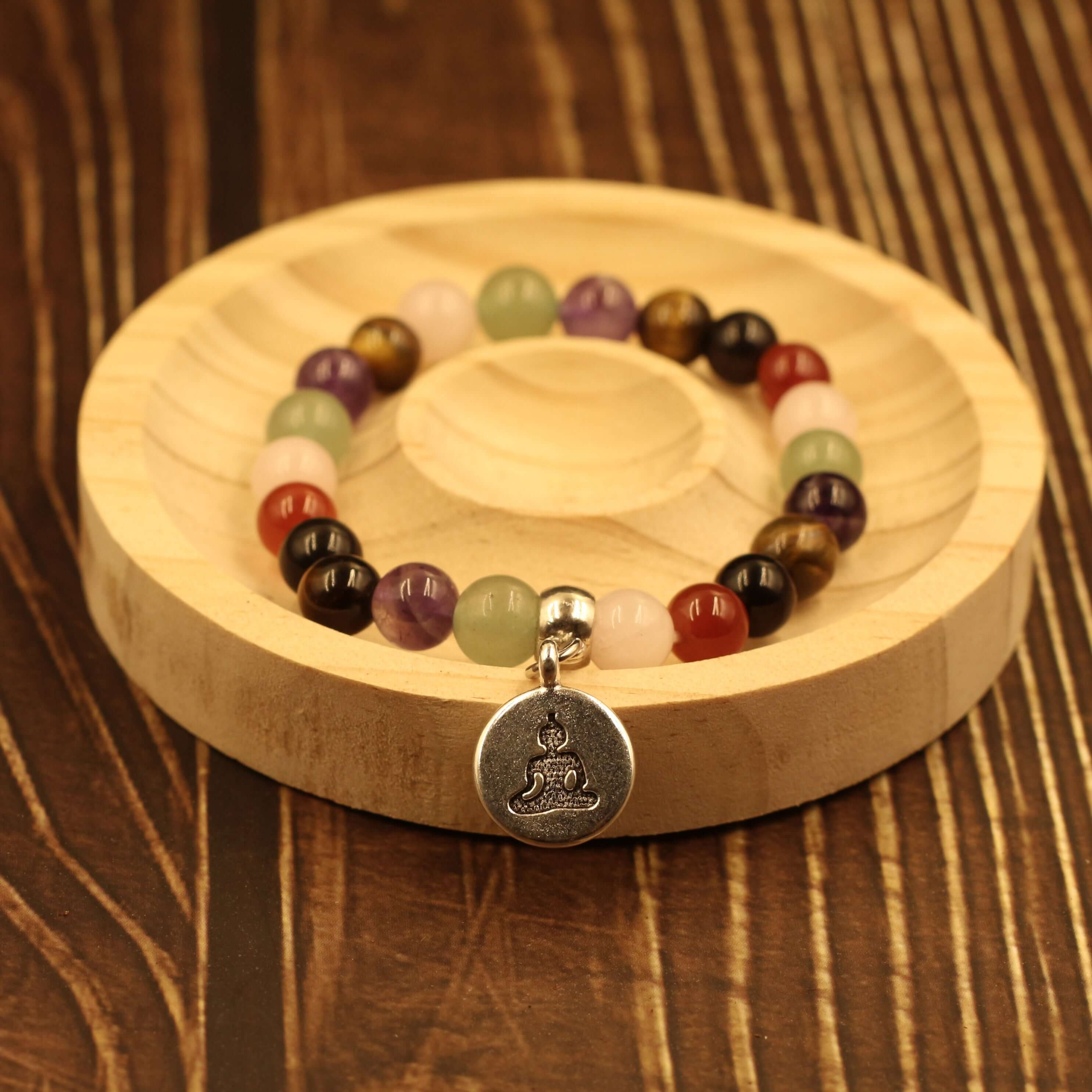 7 Chakra Healing Bracelet-Harmony & Balance with natural gemstones for energy and healing on wooden background