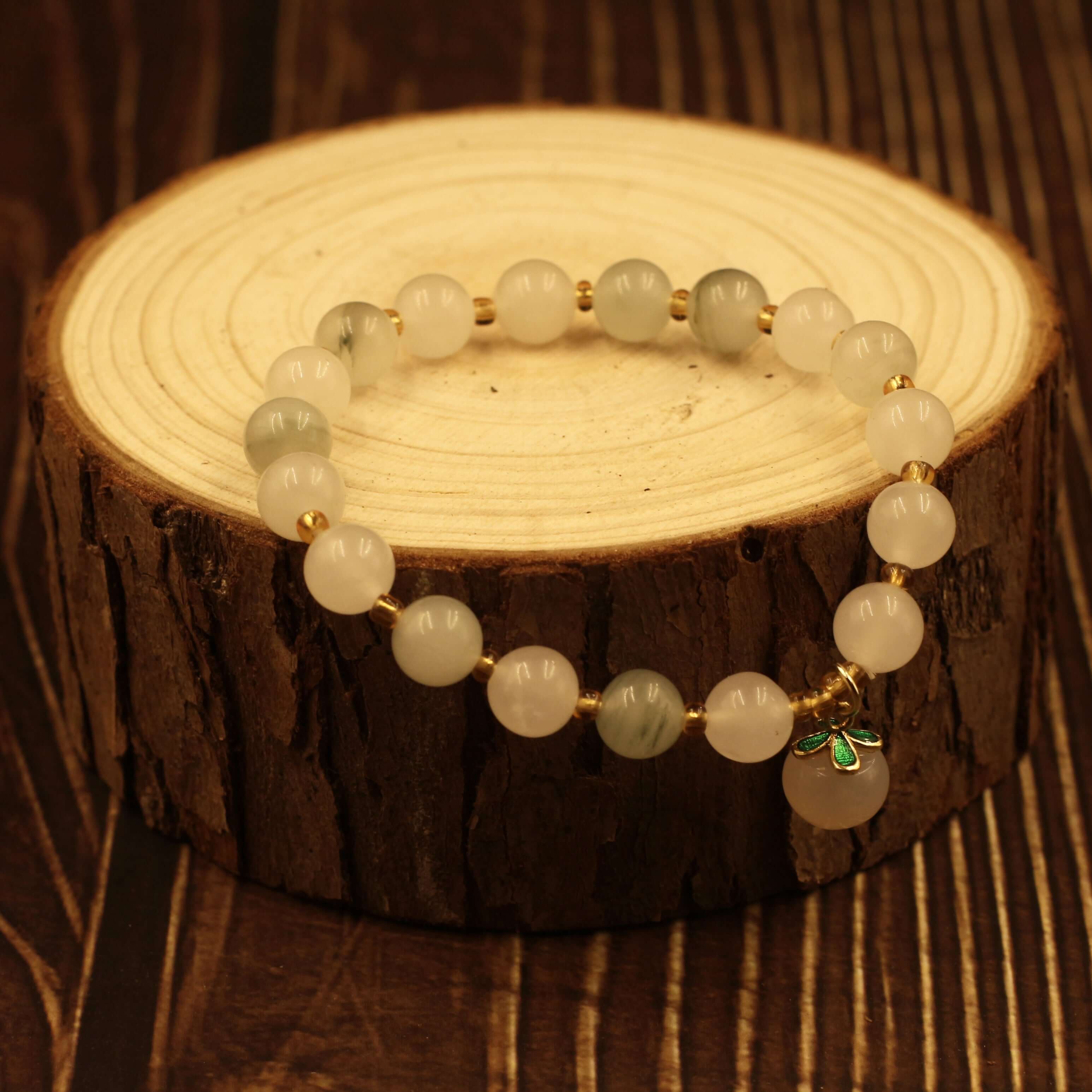 Yanyuan Agate Peach Bracelet on wooden display, showcasing its natural gemstone textures and promoting health and peace.