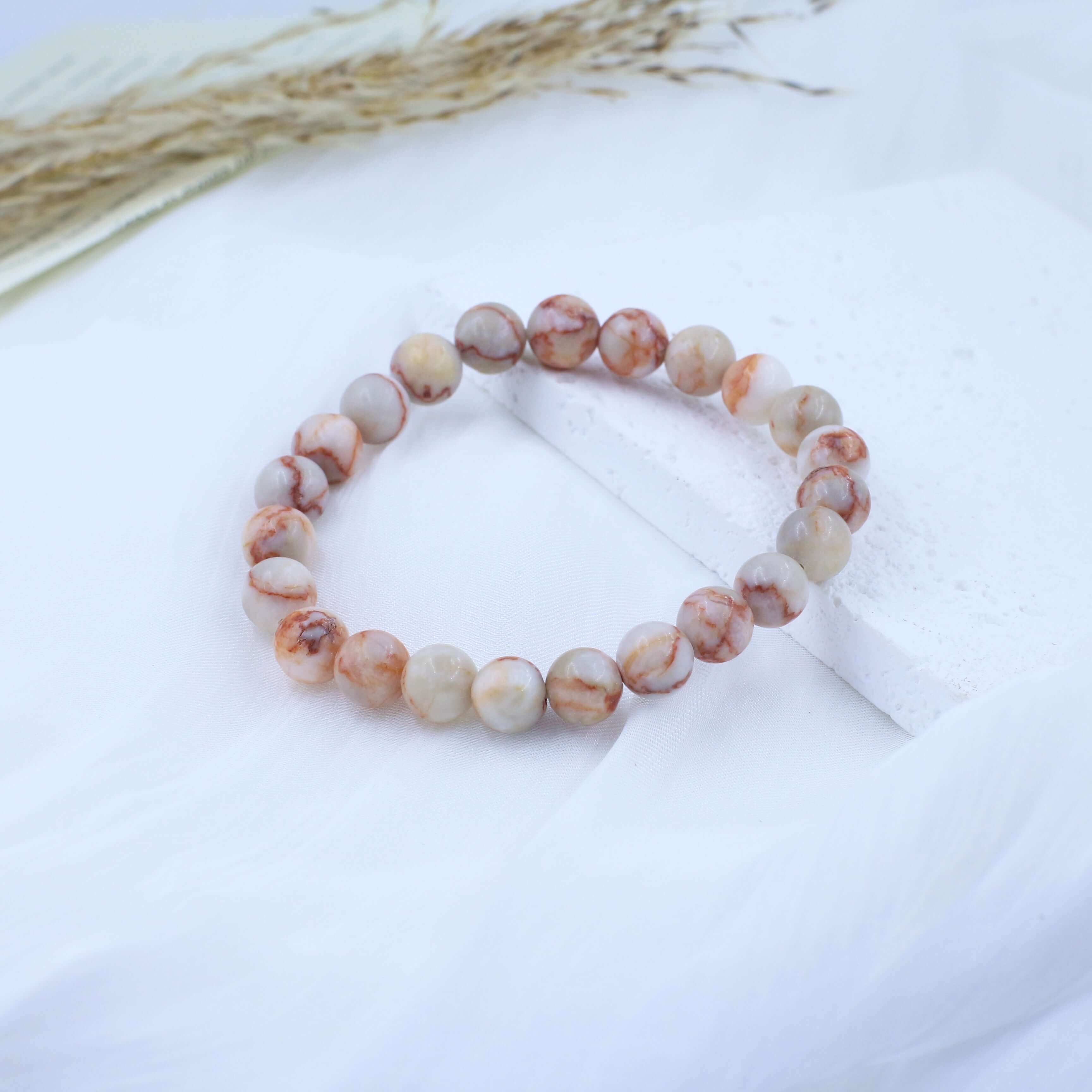 Elegant Red Grid Bracelet - Vitality, featuring vivid red stone beads symbolizing energy and life, displayed on a soft white background.