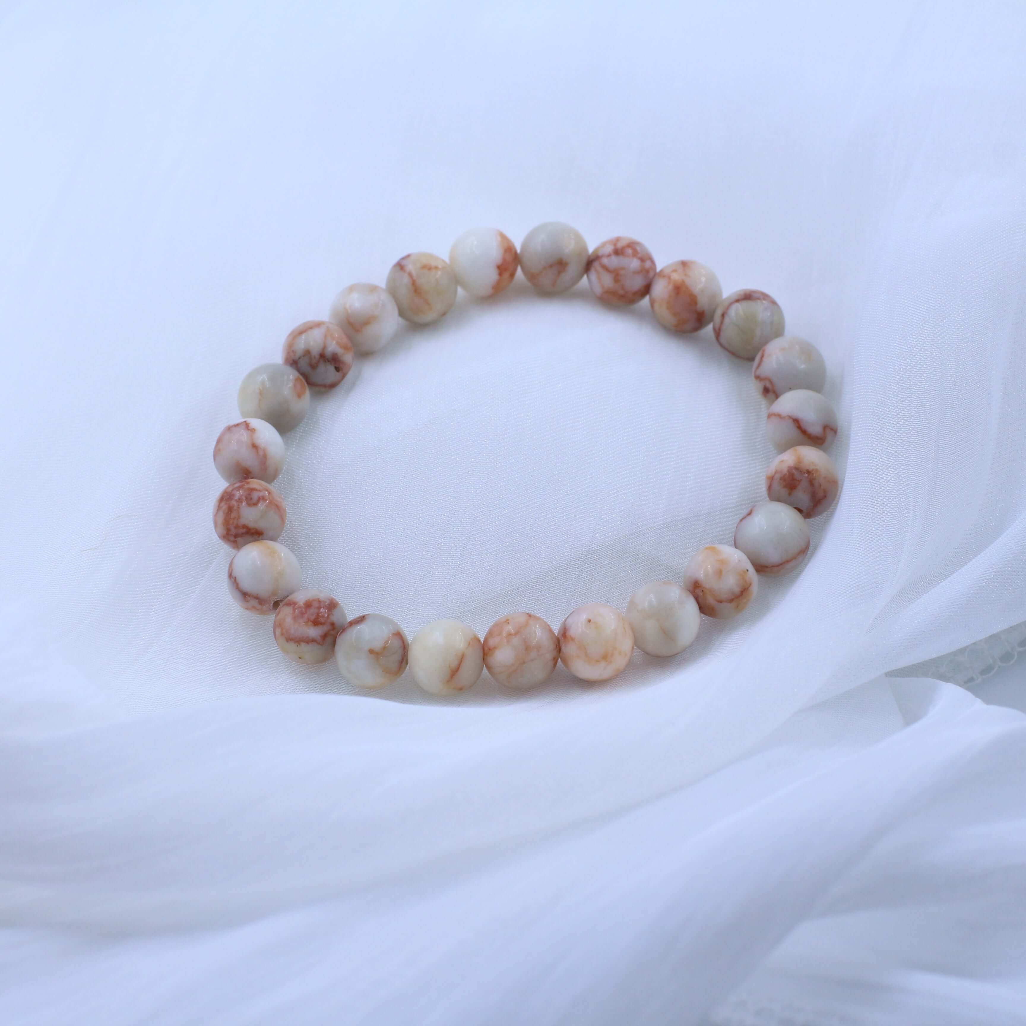 Elegant Red Grid Bracelet - Vitality with crystal stones on white fabric background, symbolizing warmth and life energy.