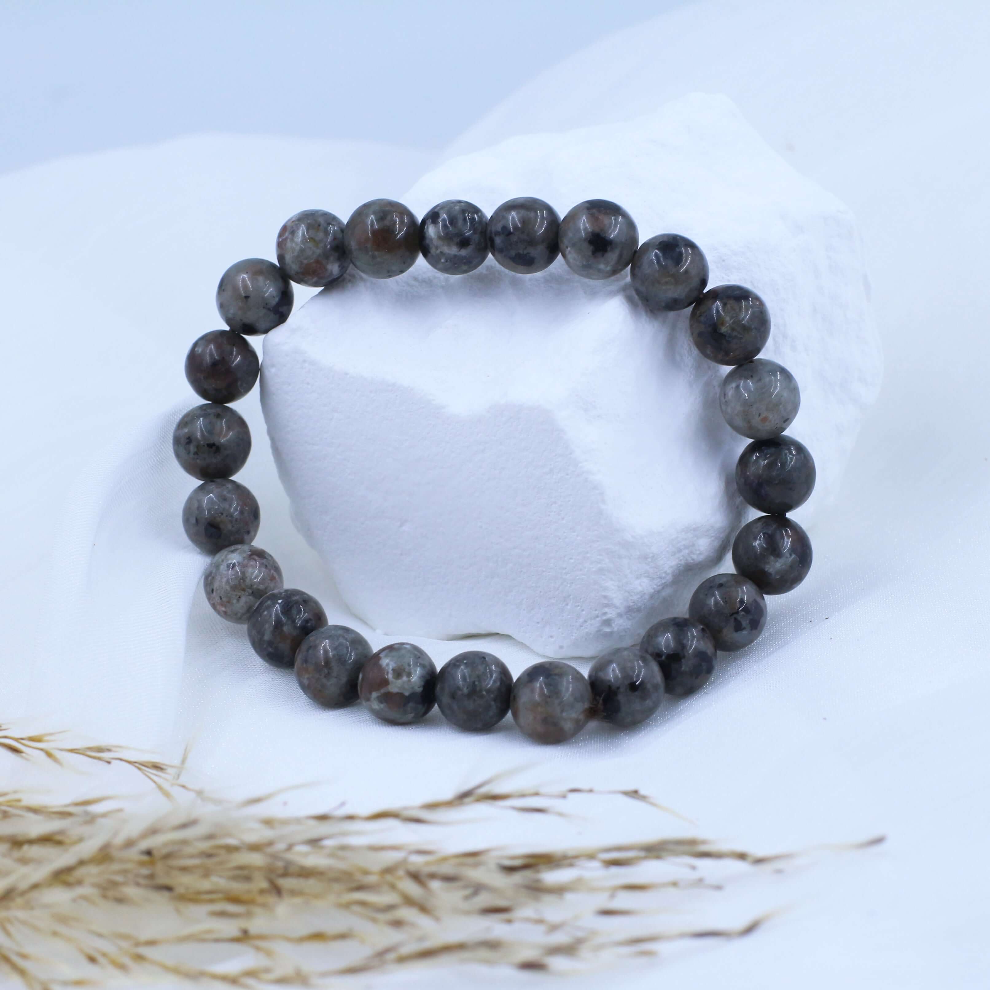 Unique Lava Stone Bracelet for Energy on display with natural background.