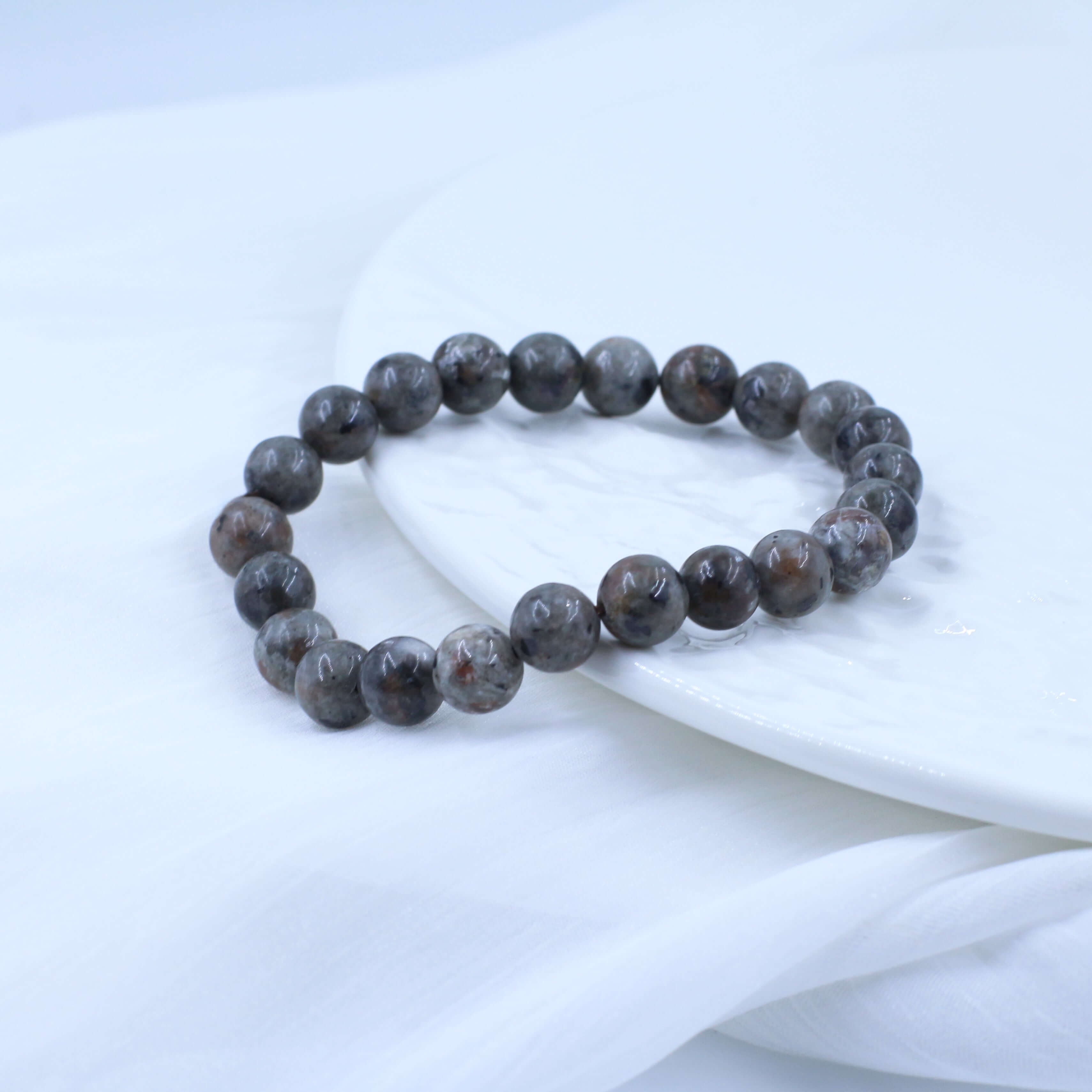 Unique Lava Stone Bracelet for Energy with natural crystal beads on a white background.