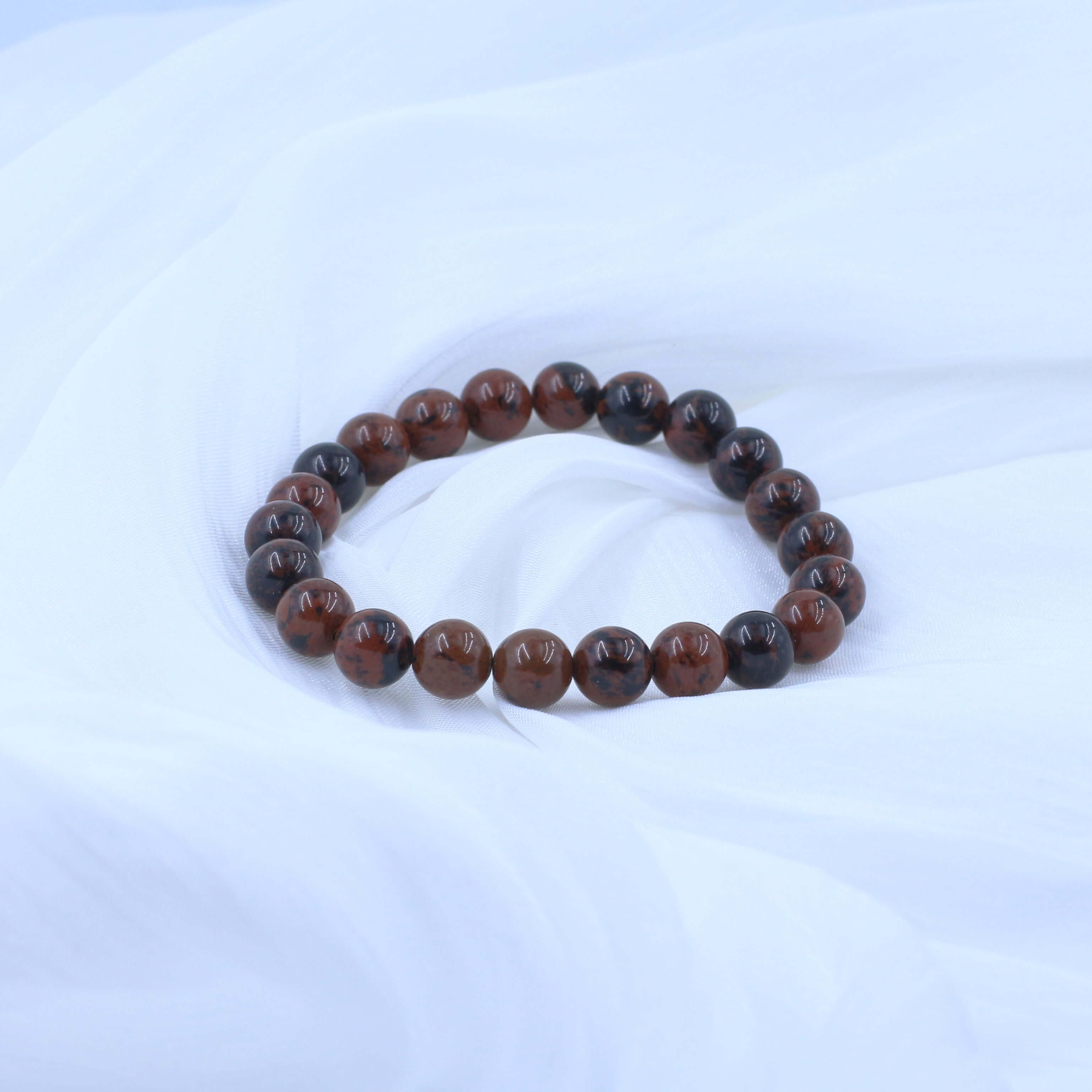 Flame Red Tiger's Eye Bracelet for Courage on white fabric background