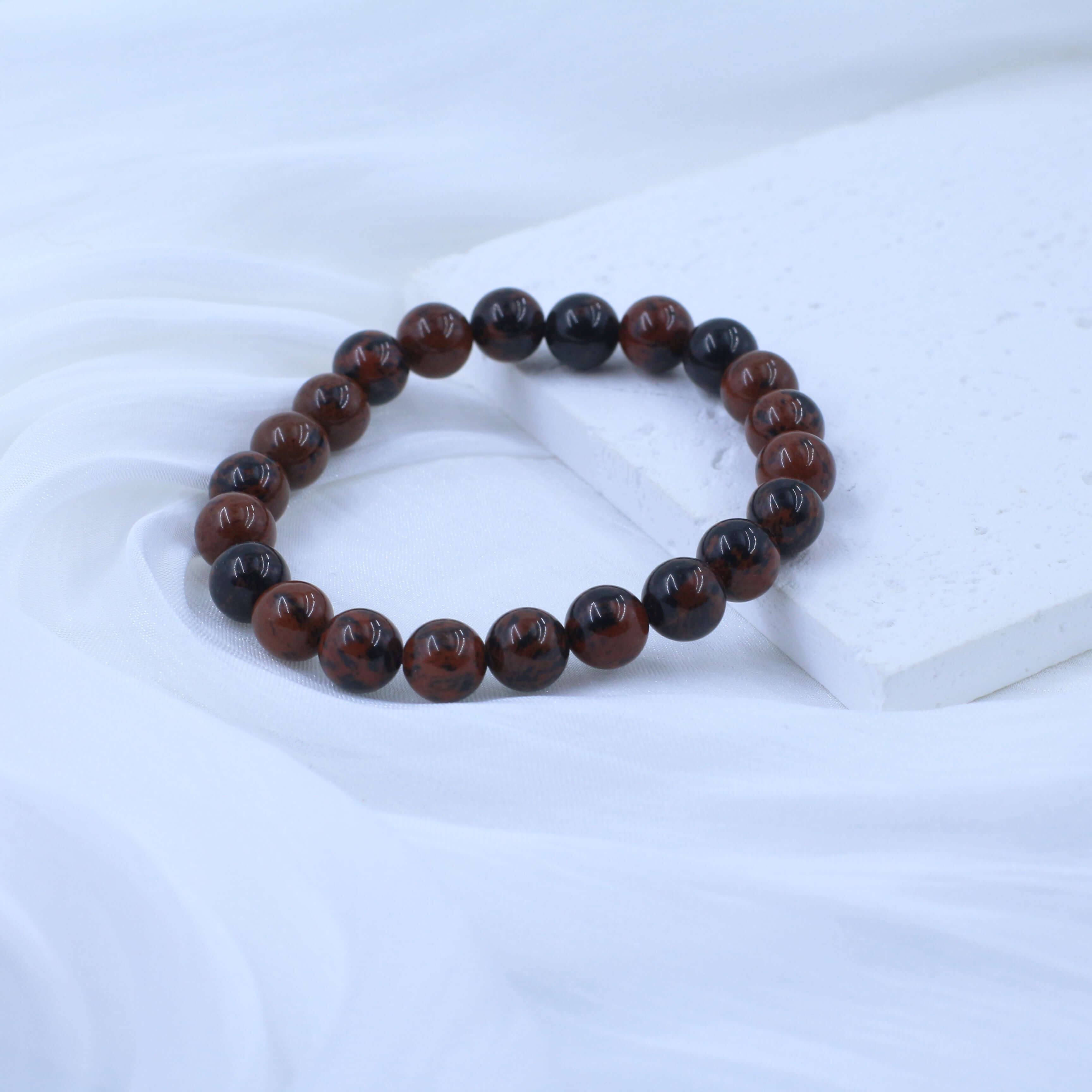 Flame Red Tiger's Eye Bracelet for Courage on white background, promotes confidence and dispels self-doubt with natural crystal.